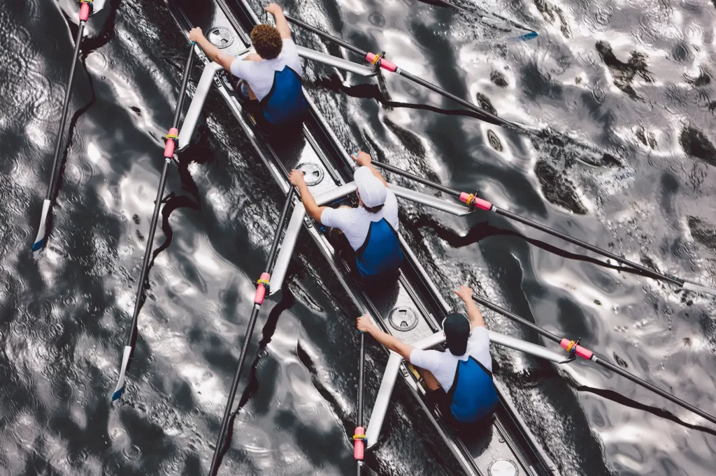overhead view of a three rowers from a crew rowing in an octuple race