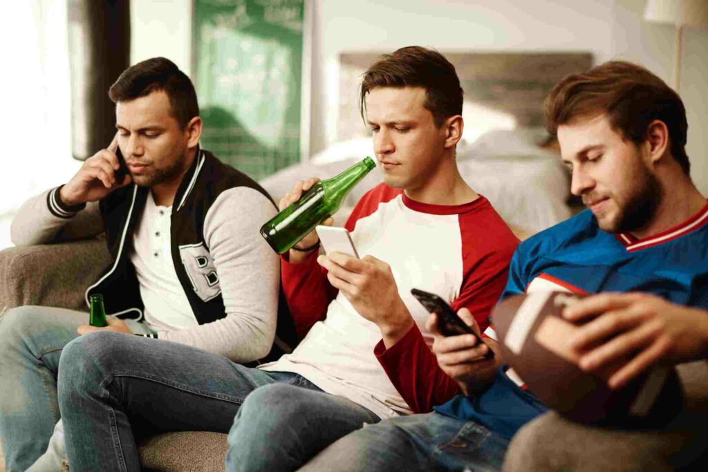 men using mobile during football game