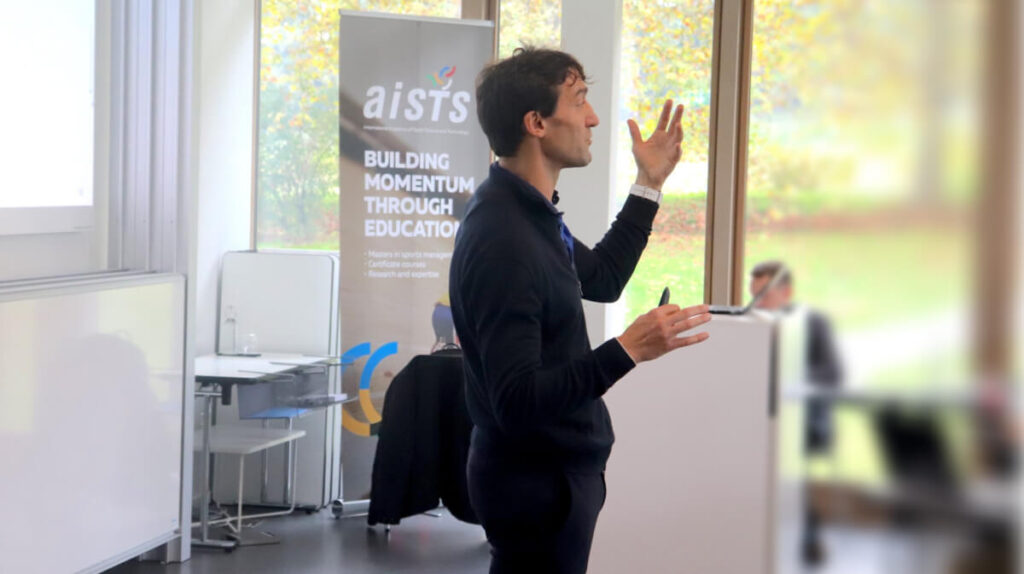 AISTS lecturer presenting a session on sports management and technology innovation.