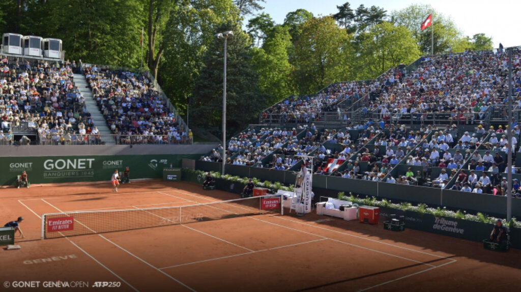 Crowded clay tennis stadium during a professional match illustrating major sports events in Switzerland.